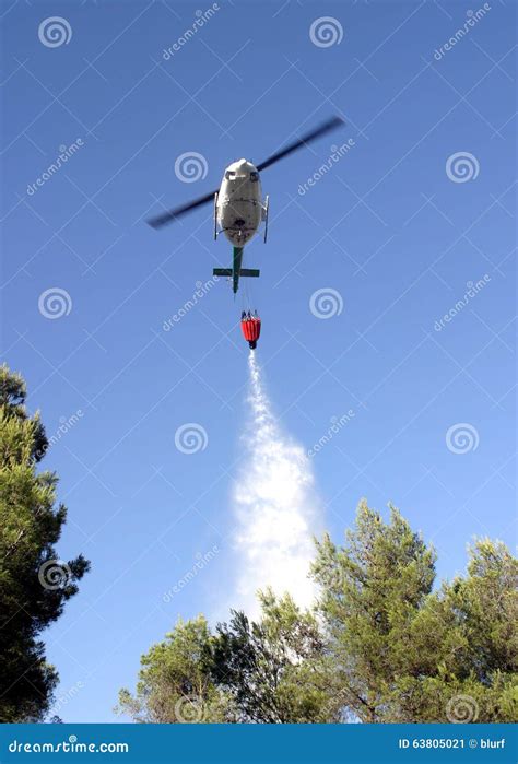 Firefight Helicopter Dropping Water Over Fire On A Forest Editorial