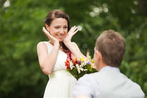 Happy Couple Standing In Green Park Kissing Smiling Laughing Stock