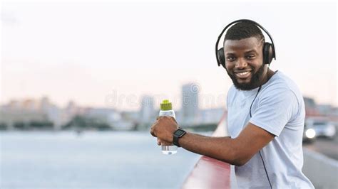 Handsome Afro Guy Resting After Exercising On The Bridge Stock Image