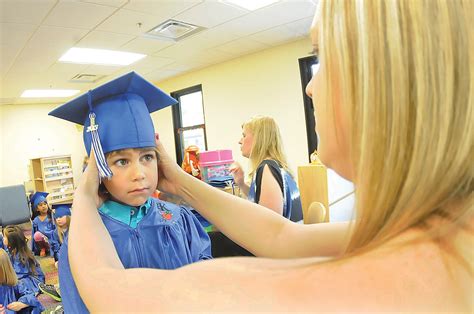 Happy First Steps Pre Kindergarten Students Don Cap Gowns For