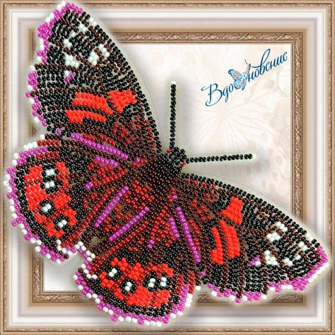The Beaded Butterfly Is Hanging In Front Of A Framed Frame With An