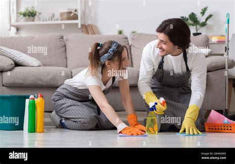 Happy Married Couple Cleaning Their Apartment Together Washing Floor