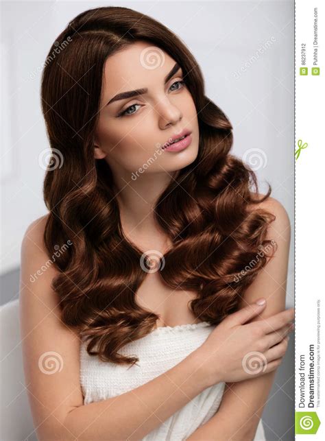 Hairstylists can transform your look by creating smart haircuts. Curly Hair Style. Beautiful Woman Model With Long Wavy ...