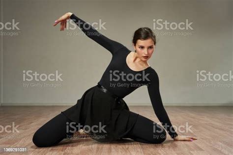 Ballerina Gracefully Stretched Out Her Hand In The Dance Sitting On The