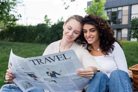 joyful lesbian couple reading travel newspaper stock image image of checkered gender 236043255