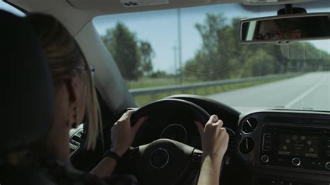 Blonde woman driving on road - Free Stock Video - Mixkit
