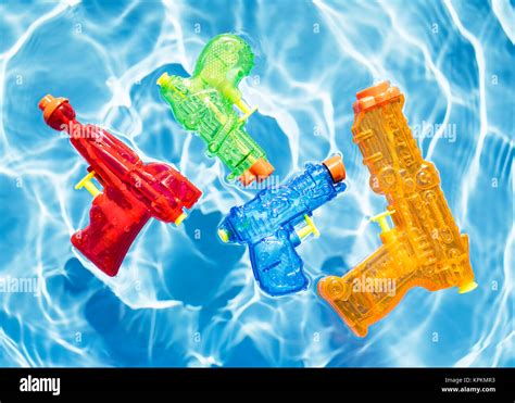 Four Colorful Squirt Guns Floating In Water Stock Photo Alamy