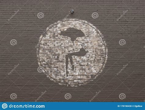 Mural Painted on Brick Wall Featuring Seated Woman with Profile Dog