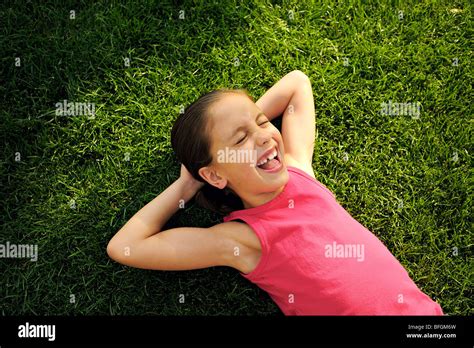 Young Girl Laying On Lawn With Hands Behind Head Toronto Ontario