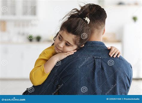 Closeup Shot Of Caring Dad Comforting Upset Little Daughter At Home