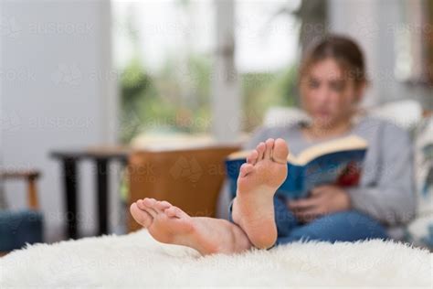 Image Of Person Reading With Feet Up On Footstool Austockphoto
