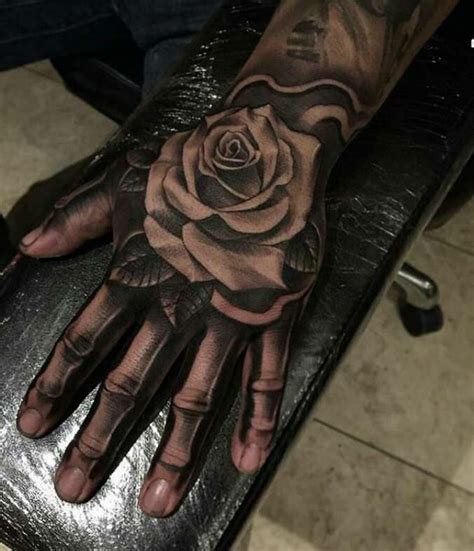 Rose On Skeleton Hand Skull Hand Tattoo Rose Tattoos For Men Rose
