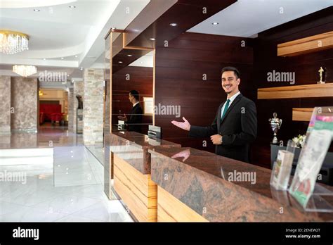 Receptionist Welcoming Guests To A Hotel Concept Of Tourism Stock