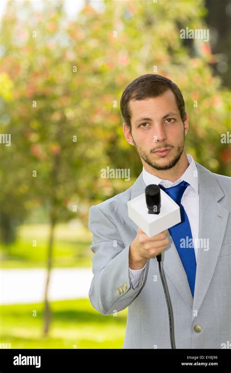 Successful Handsome Male News Reporter Wearing Light Grey Suit Working