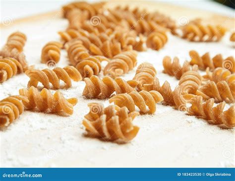 Spiral Shaped Pasta On A Board Stock Photo Image Of Scattered