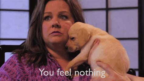 A Woman Holding A Puppy In Her Arms With The Words You Feel Nothing On It