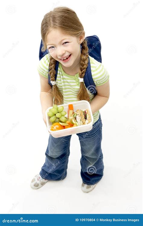 Studio Portrait Of Smiling Girl Holding Lunchbox Stock Photo Image Of