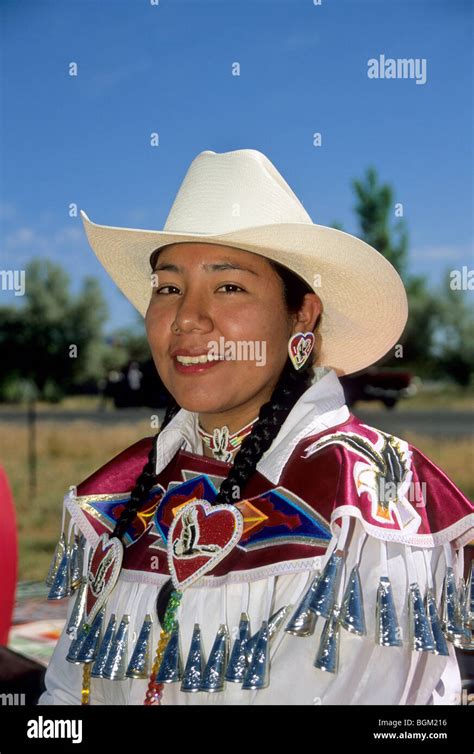 Native American Teenage Girl Wears A Cowboy Had And A Jingle Dress With