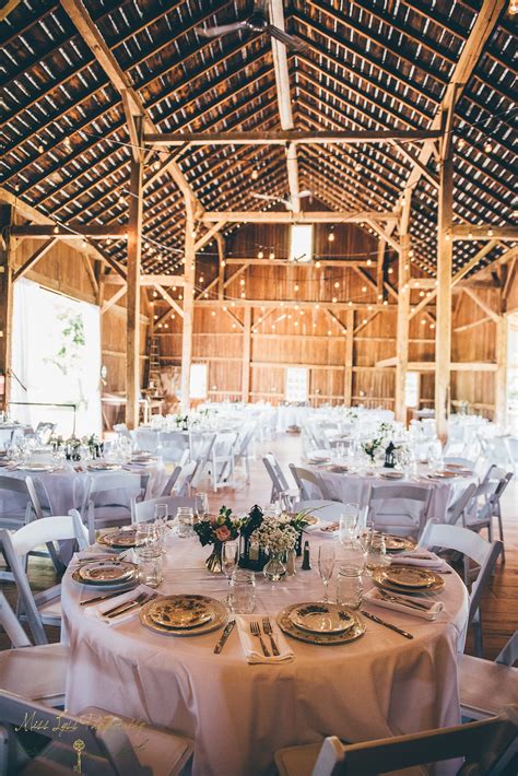 Reception area for up to 200 people with illuminated with chandeliers, white market lights and other beautiful lighting. Gallery - Hidden Vineyard Wedding Barn