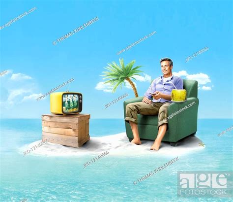 Happy Man Stranded On Desert Island Watching Television Stock Photo