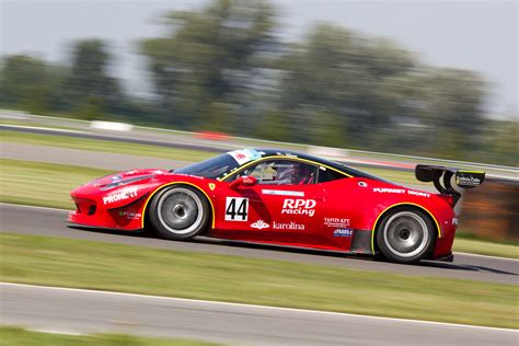Red Racing Car on Race Track during Daytime · Free Stock Photo