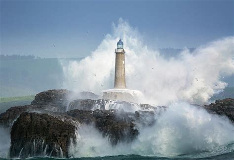 Waves Crashing Around Lighthouse Photograph By Sergio Saavedra Pixels