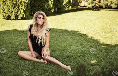 Beautiful Tanned Blonde On The Grass Summer Vacation And Relaxation