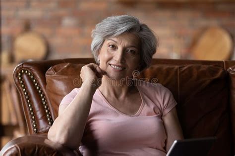 Portrait Of Smiling Senior Woman Relaxing At Home Stock Photo Image