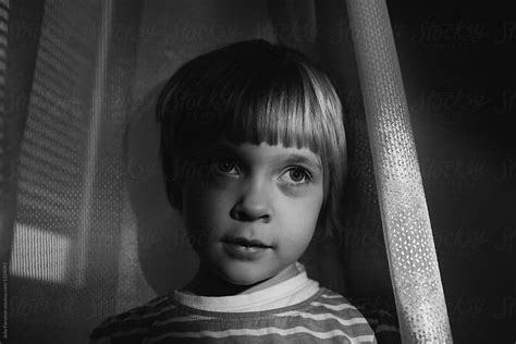 Black And White Close Up Portrait Of Child By A Curtain By Julia