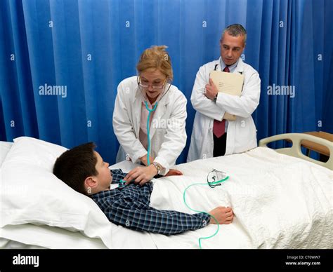 Doctor Examining Patient In Hospital Stock Photo Alamy