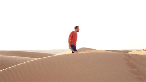 Young Man Walking On The Desert Slow Motion Stock Footage Video
