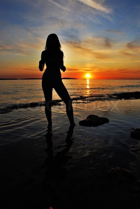 Beautiful Woman Silhouette Posing At Sea Sunset Stock Photo Colourbox