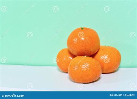 Pile Of Mandarin Oranges And Several Segments Of Peeled Mandarin Stock