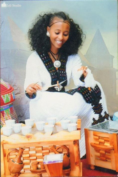 A Beautiful Habesha Woman Serving Coffee Buna And Spinning Cotton In