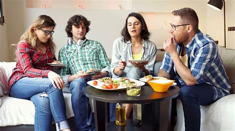 Group Of Friends Talking With Each Other While Eating