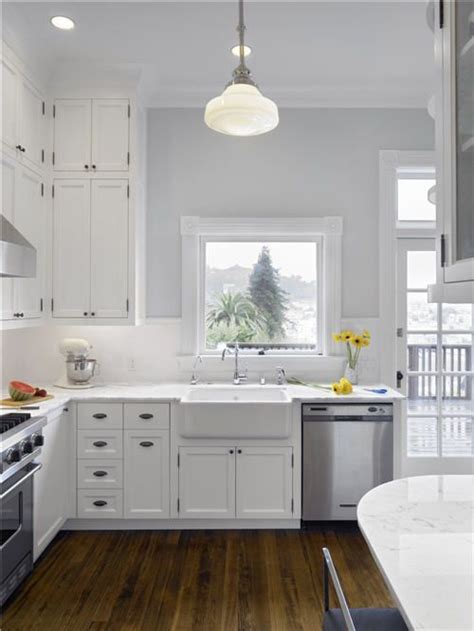 The wall white cabinets and the gray backsplash tiles complement the island cabinets and the marble countertop! white cabinets kitchen grey walls | Bright kitchen ...