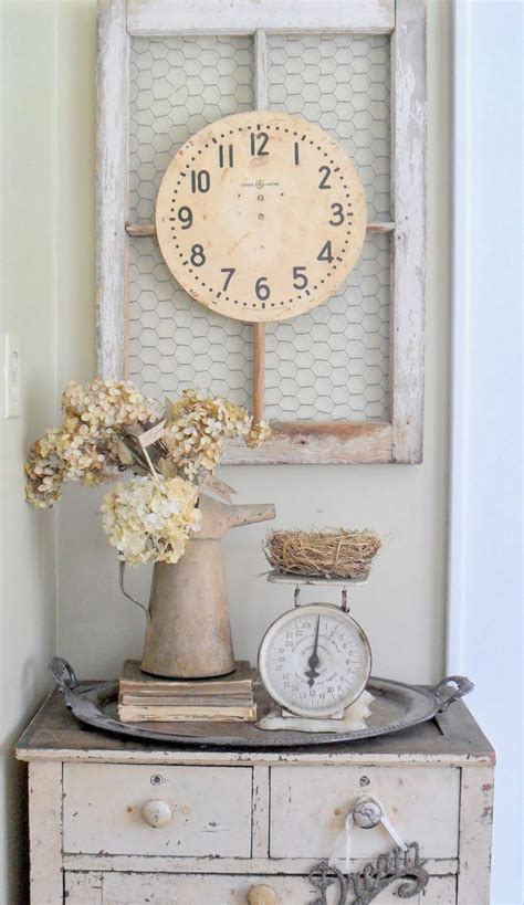 An Old Dresser Has A Clock And Flowers On It