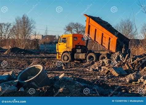 Garbage Dump Truck Unloading Construction Debris Into Landfill Stock