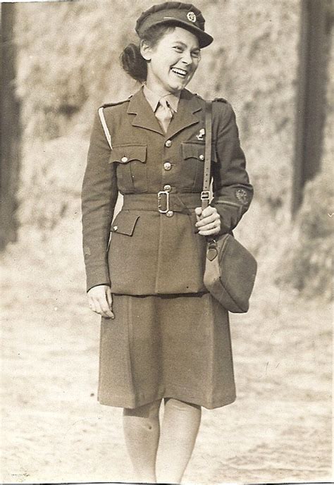 An Old Black And White Photo Of A Woman In Uniform