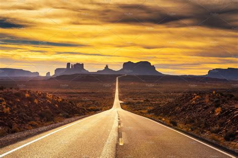 Desert Road Leading To Monument Valley At Sunset Stock Photo Containing