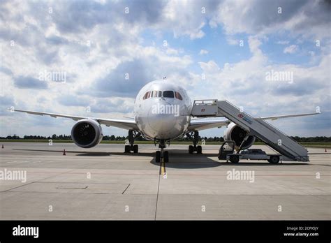 Front View Of Boeing 787 8 Dreamliner With Passenger Boarding Stairs