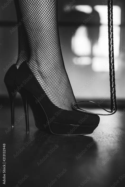 Dominant Woman In Black Fishnet Stockings And High Heels With Riding