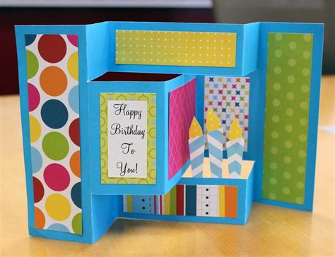 Begin by folding the paper in half 3 times and then fold down the sides to a triangle. a dash of scraps: How to make a Birthday pop-up card