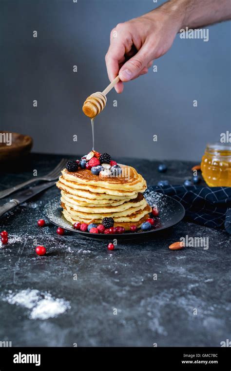Pancakes For Breakfast Male Hand Holding Honey Spoon And Pouring Honey