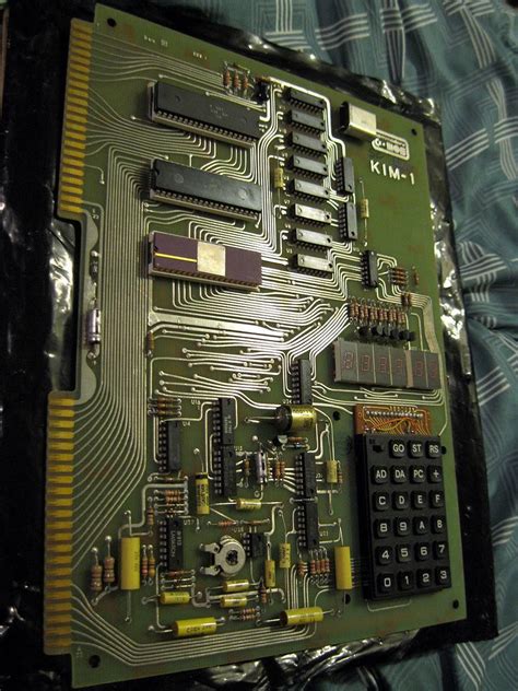 The Electronic Board Has Many Components Attached To It And Is Being