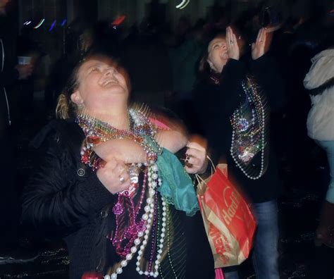 a women shows her to get beads during a night on bourbon street in new orleans women
