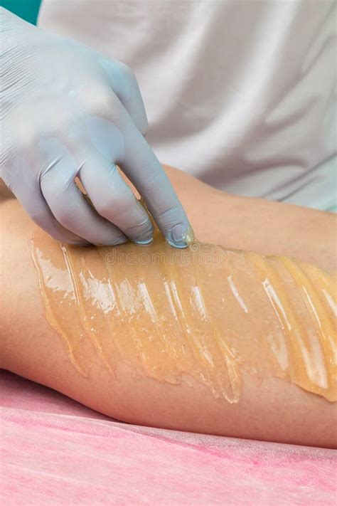 removing unnecessary hair on the legs procedure sugaring in a beauty salon depilatory sugar