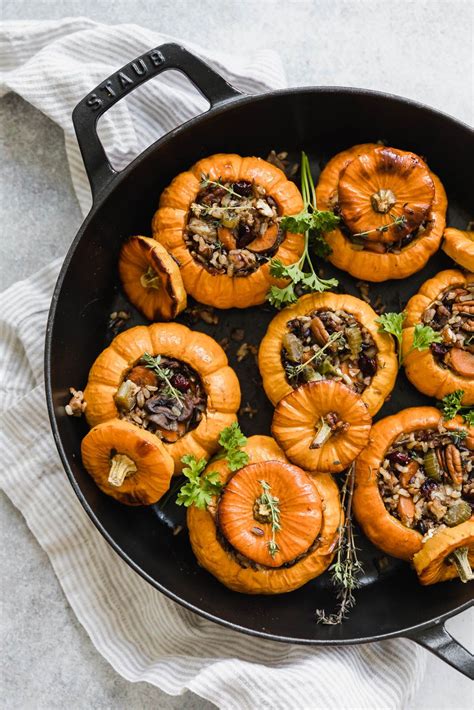 baked stuffed pumpkins in a skillet with herbs and nuts on the top ready to be eaten