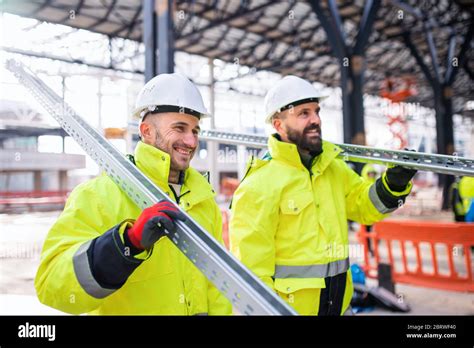 Men Workers Walking Outdoors On Construction Site Working Stock Photo