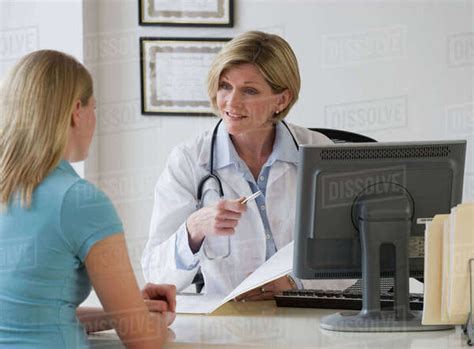 Female Doctor Talking To Patient Stock Photo Dissolve